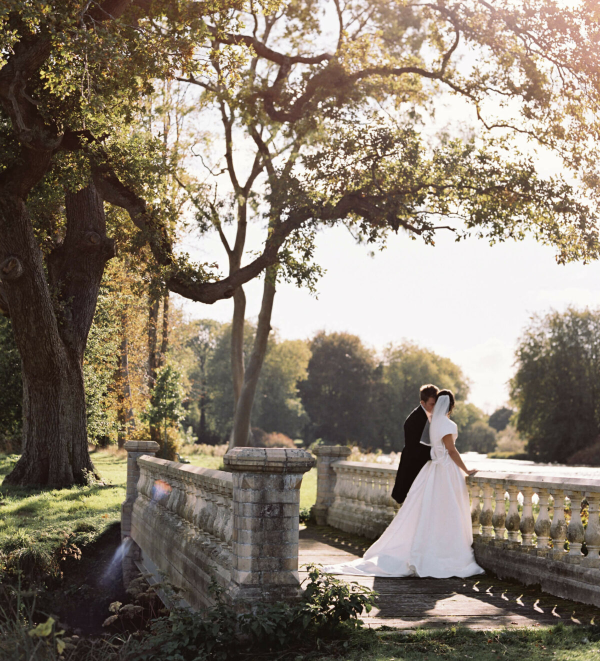 Wedding Trends of 2023, wedding couples portrait on Lake Lawn bridge at St Giles House.