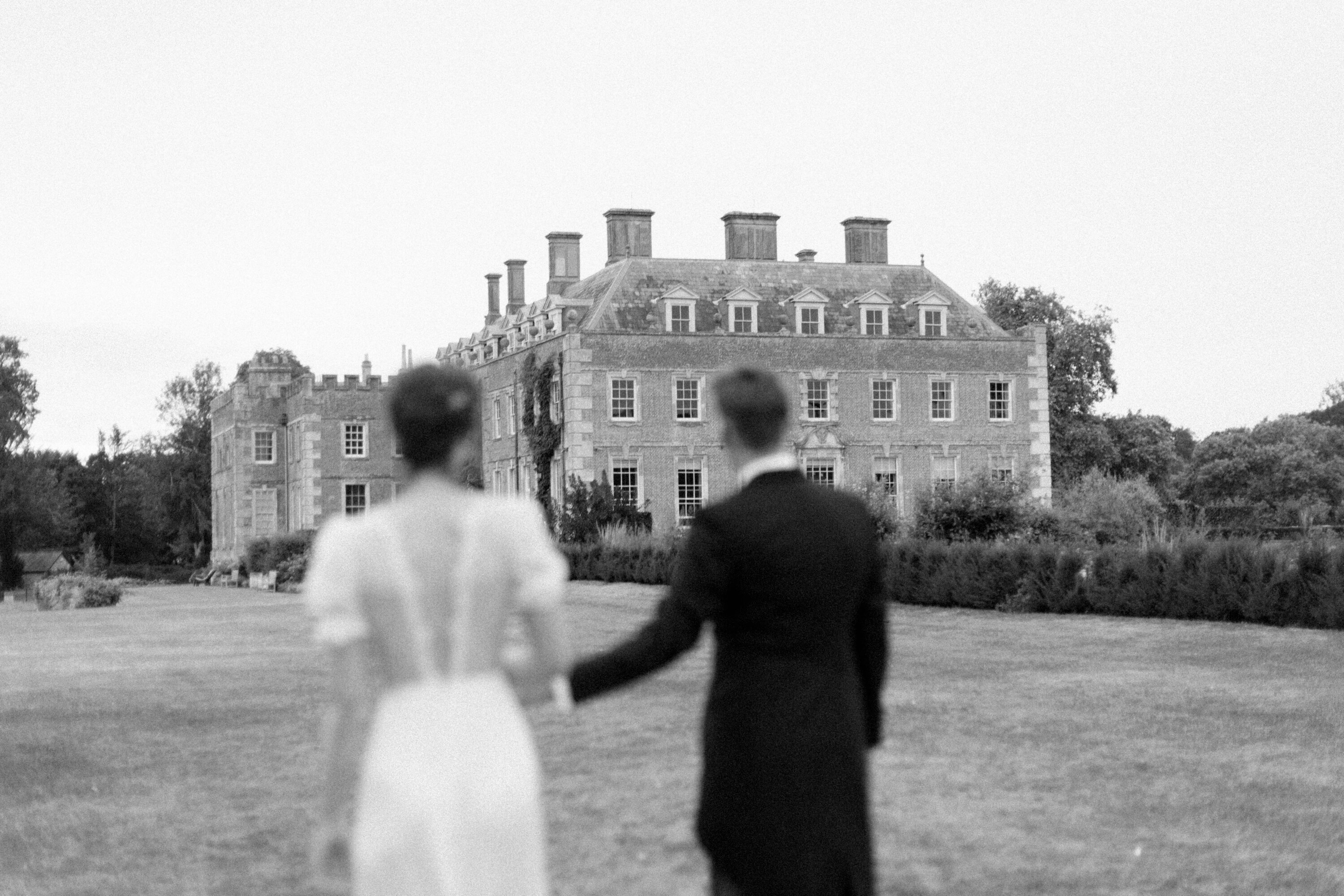 Bride and groom look back at their wedding venue in late September at St Giles House
