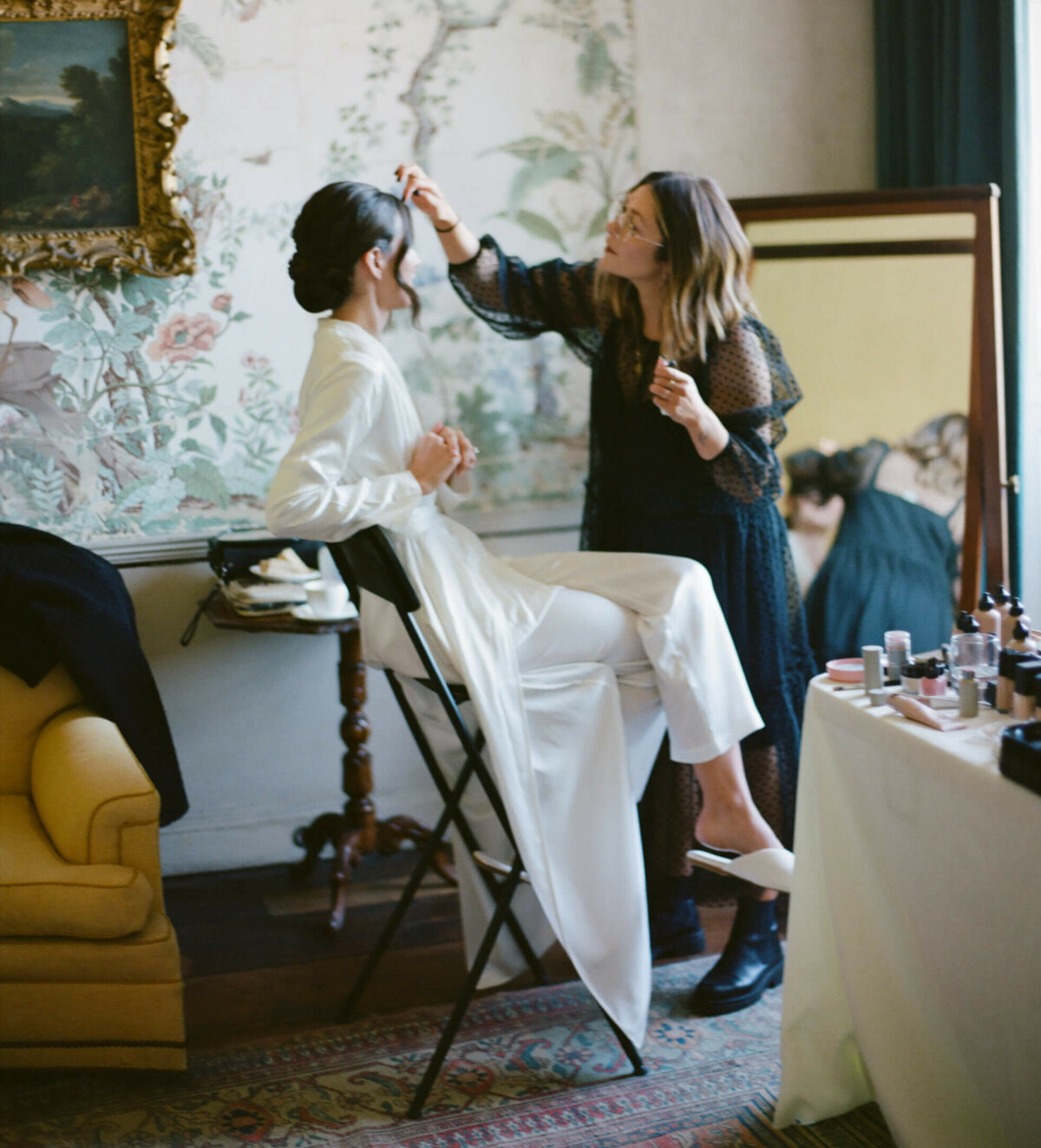 Bride in Bridal Suite getting ready in the Japan Room at St Giles House in her White Silk Pyjamas.
